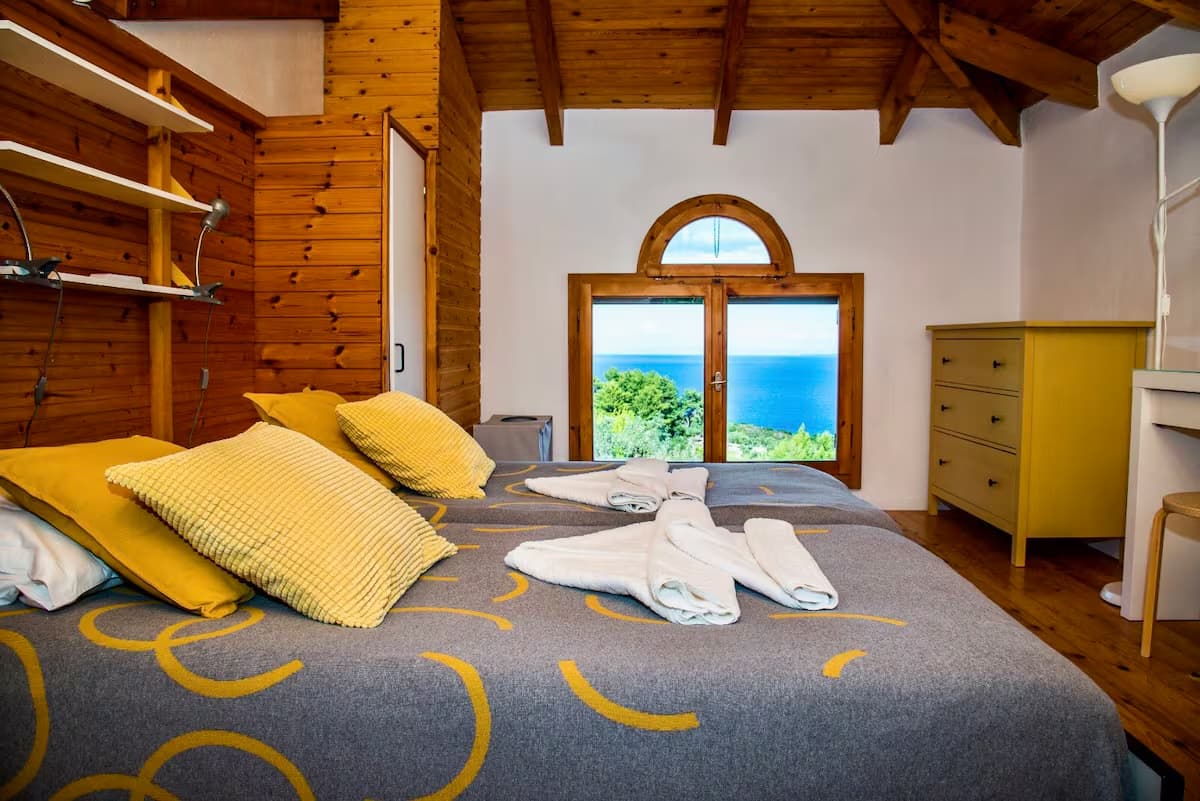 Bedroom with sea views and wooden ceiling at retreat villa in Zakynthos