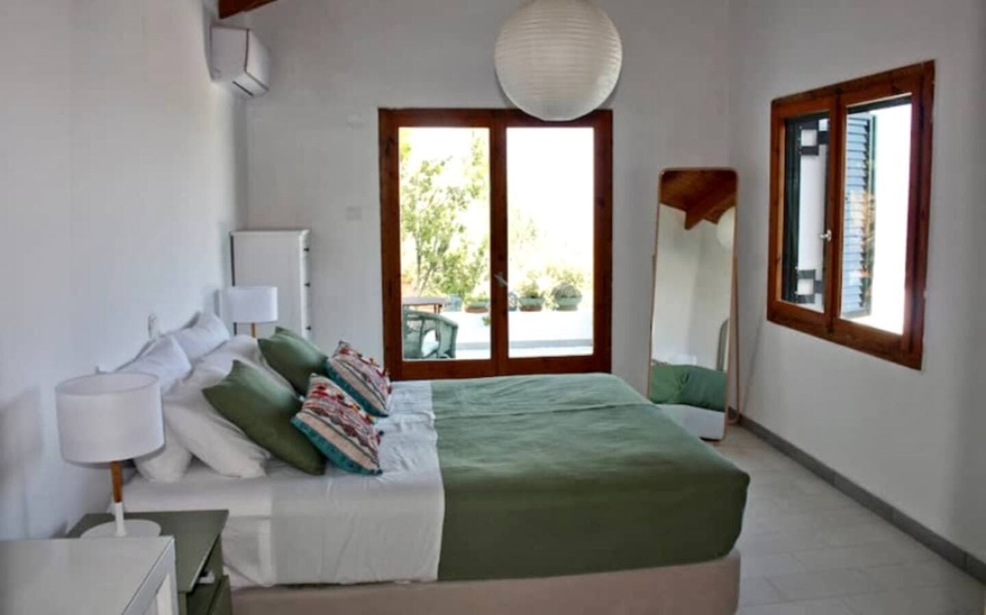 Peaceful bedroom with garden views at women's wellness retreat in Zakynthos, Greece